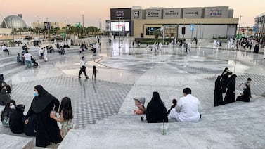 People sit outside by a fountain near a shopping centre in Saudi Arabia's capital Riyadh on October 31, 2020.  - Misyar, a no-strings-attached marriage, often done in secret, is fast pervading Saudi society -- a boon for cash-strapped men unable to afford expensive traditional weddings, but deplored by critics for legitimising promiscuity.  The practice, usually a temporary alliance in which the wife waives some conventional marriage rights such as cohabitation and financial support, has been legally permitted in the conservative Muslim kingdom for decades.  (Photo by FAYEZ NURELDINE  /  AFP)