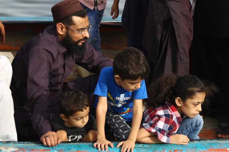 A father sits with his children as Pakistan observes Father's Day in Karachi. EPA