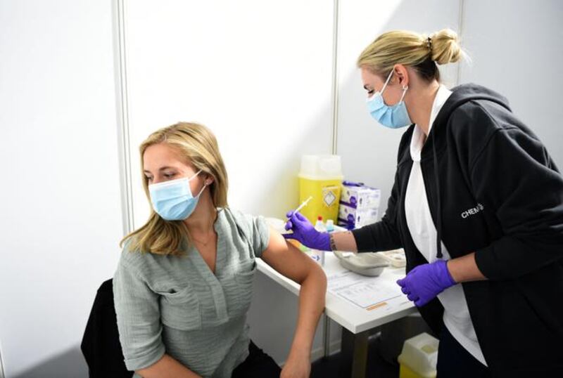 A woman receiving a Pfizer BioNTech vaccine