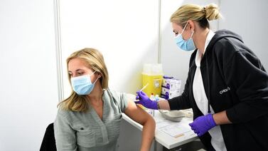 A doctor injects a woman with a dose of the Pfizer-BioNTech Covid-19 vaccine in Leverkusen, Germany. AFP