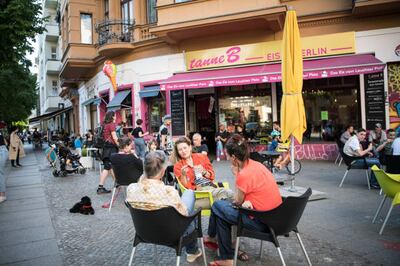 People at a cafe. Tourism is gradually recovering as movement restrictions ease. Getty Images.