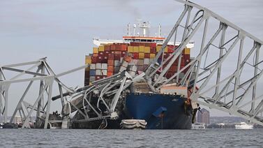 The steel frame of the Francis Scott Key Bridge sits on top of the container ship Dali after the bridge collapsed in Baltimore. AFP