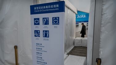 BEIJING, CHINA - JANUARY 19: A list of COVID prevention measures are seen on a sign at a security check outside a fenced area next to the National Stadium, also known as the Bird"u2019s Nest, that will be part of the closed loop "u2018bubble"u2019 for visitors and locals taking part in the Beijing 2022 Winter Olympics and Paralympics, at the Olympic Park on January 19, 2022 in Beijing, China. Foreign and local athletes, officials, journalists, and support workers for the Winter Olympics are required to stay in a bubble to prevent the spread of coronavirus as China continues to maintain its zero COIVD policy. The games are set to open on February 4th.  (Photo by Kevin Frayer / Getty Images)