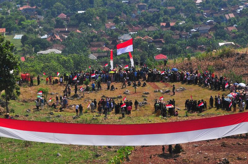 People join a ceremony for celebrating Indonesia's 77th Independence Day at Kedumulyo village, in Pati, Central Java province, Indonesia, August 17, 2022, in this photo taken by Antara Foto.  Antara Foto/Yusuf Nugroho/ via REUTERS    ATTENTION EDITORS - THIS IMAGE HAS BEEN SUPPLIED BY A THIRD PARTY.  MANDATORY CREDIT.  INDONESIA OUT.  NO COMMERCIAL OR EDITORIAL SALES IN INDONESIA. 