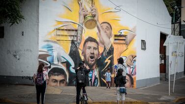 People take pictures of a mural of Lionel Messi by the artist Maximiliano Bagnasco holding the World Cup trophy after the triumph of Argentina in the FIFA World Cup Qatar 2022, at the Palermo neighborhood in the City of Buenos Aires, Argentina, 23 December 2022.   EPA / Juan Ignacio Roncoroni