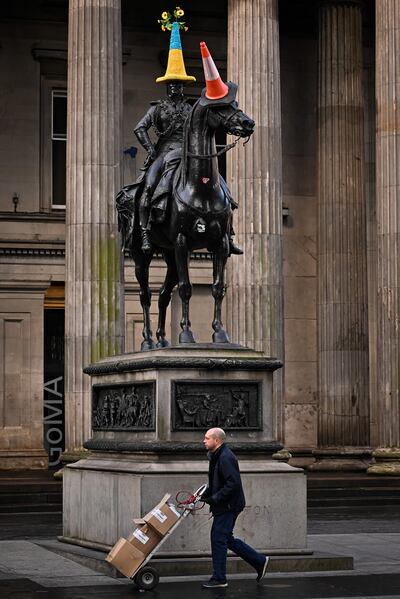 GLASGOW, SCOTLAND - MARCH 07:  The Duke of Wellington Statue wears a traffic cone with a knitted cover in the colours of the Ukraine flag on March 07, 2022 in Glasgow, Scotland. Russia invaded neighbouring Ukraine on 24th February 2022, its actions have met with worldwide condemnation with rallies, protests, peace marches and acts of solidarity taking place in cities across the globe. (Photo by Jeff J Mitchell / Getty Images)
