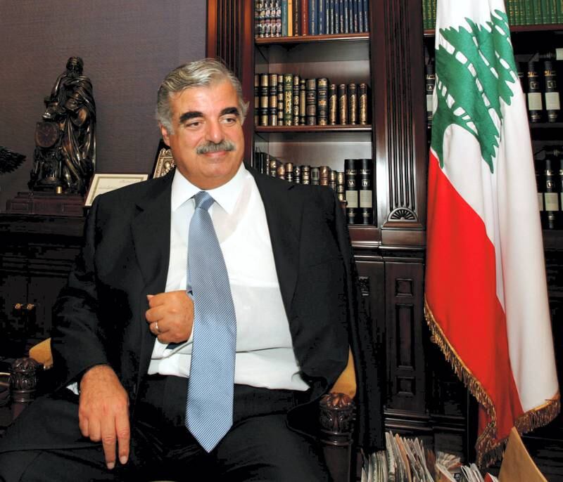 Former Lebanese prime minister Rafik Hariri, his fractured shoulder in a sling, smiles during an interview at his office in Beirut, in September 2004. He was assassinated in 2005. AFP