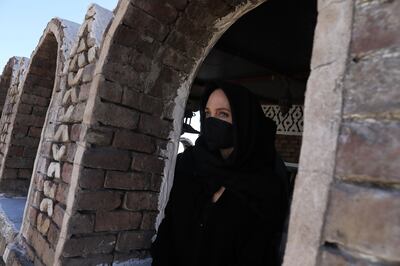 SANA'A, YEMEN - MARCH 08: In this handout photo issued by the United Nations High Commission for Refugees, Special envoy Angelina Jolie looks out a window of a historic building in the Old City of Sana's on March 8, 2022 in Sana'a, Yemen. (Photo by Marwan Tahtah / UNHCR via Getty Images)