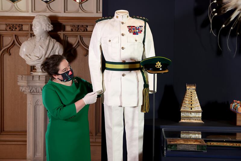A curator adjusts a display of items at the exhibition at Windsor Castle. Getty Images