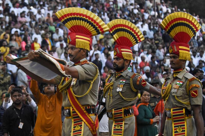 This picture taken on August 15, 2022, shows Indian Border Security Force (BSF) soldiers taking part in the Beating the Retreat ceremony during India's 75th Independence Day celebrations at the India-Pakistan Wagah border post, about 35km from Amritsar.  (Photo by Narinder NANU  /  AFP)