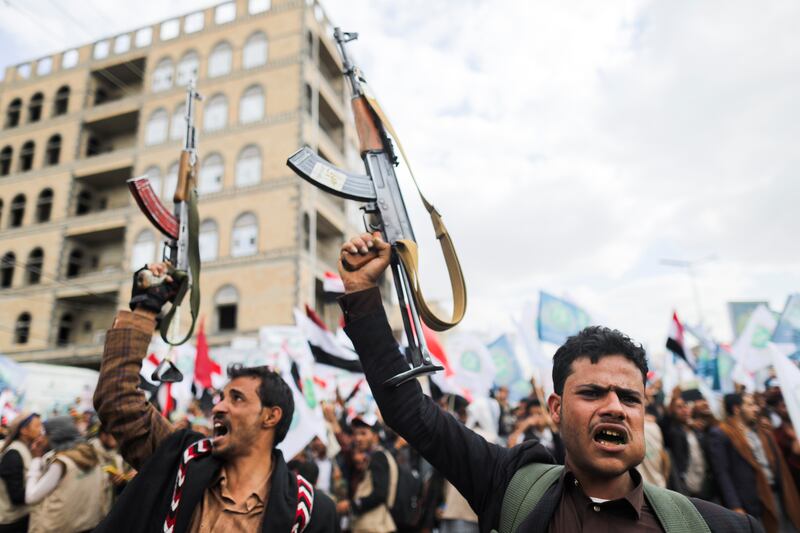 Supporters of Yemen's Houthis hold up their rifles as they rally to celebrate the seventh anniversary of the ousting of the government in Sanaa, Yemen, on September 21, 2021. Reuters