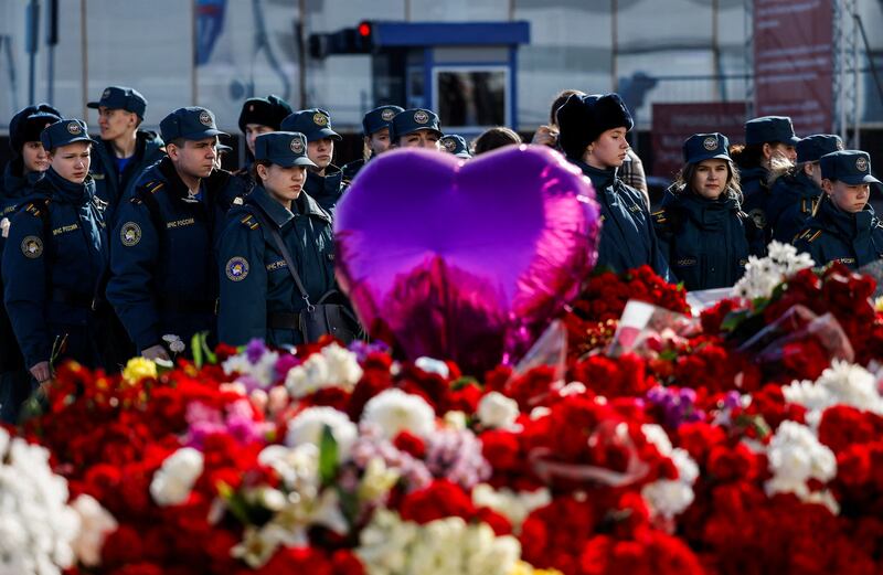 Cadets of the Fire and Rescue College stand in front of at a makeshift memorial near the Crocus City Hall following a deadly attack on the concert venue in the Moscow Region, Russia, on March 27.  Reuters 