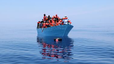 Doctors Without Borders workers rescue migrants from a boat in the Mediterranean Sea. Reuters