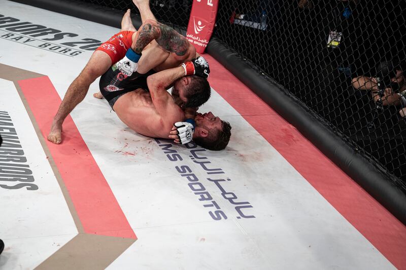 Ray Borg, in red, has Jesse Arnett pinned to the canvas in the UAE Warriors 20 at the Jiu-Jitsu Arena in Abu Dhabi.