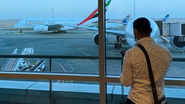 A passenger waits for his Emirates Airlines' flight departure to Dubai at Cairo's International Airport, Egypt July 20, 2021. Reuters