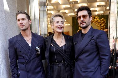 MILAN, ITALY - FEBRUARY 26: Adam Senn, Sharon Stone and Sam Webb attend a photocall during a Dolce & Gabbana boutique event during the Milan Fashion Week Fall/Winter 2022/2023 on February 26, 2022 in Milan, Italy. (Photo by Andreas Rentz / Getty Images)
