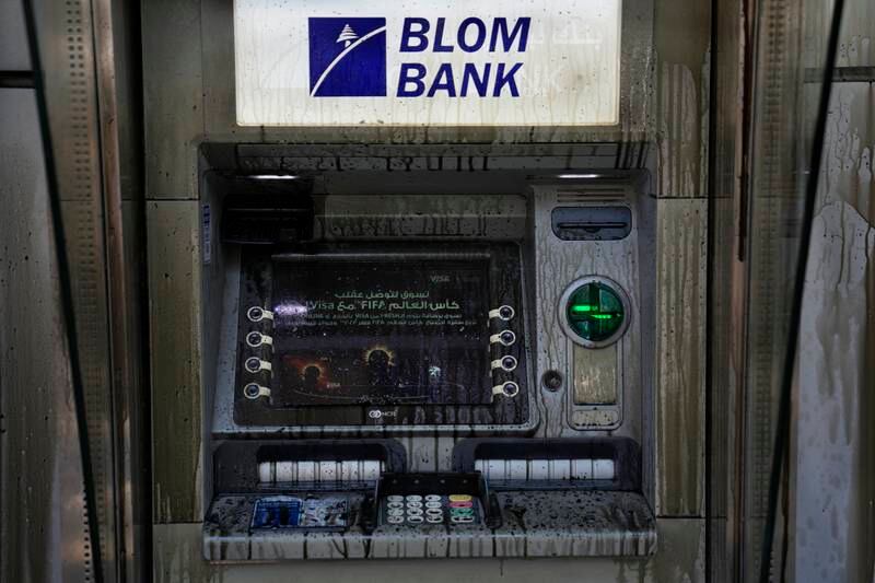 An ATM is covered with diesel fuel, vandalised by angry depositors. AP photo