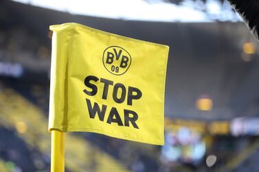 DORTMUND, GERMANY - MARCH 13: A corner flag which reads 'Stop War' is seen inside the stadium to indicate peace and sympathy with Ukraine prior to the Bundesliga match between Borussia Dortmund and DSC Arminia Bielefeld at Signal Iduna Park on March 13, 2022 in Dortmund, Germany. (Photo by Christof Koepsel / Getty Images)
