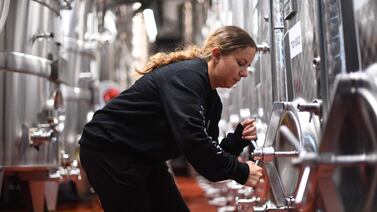 A worker inspects wine vats at Ridgeview Estate's winery near Burgess Hill, southern England, on June 22, 2021.  - Problems have shaken the lives of many businesses across the country since the UK's effective exit from the single market in early January, without it being yet possible to know whether they will be temporary or sustainable.  "We had no recruitment problem, it's only since this year that we have seen labour shortages.  It's really complicated with the pandemic, the travel restrictions, to see where the pressures are coming but we think that Brexit made people stay at home because we did not make it easy for them to come", Tamara Roberts, CEO of Ridgeview Estate Winery told AFP.  (Photo by DANIEL LEAL-OLIVAS  /  AFP)  /  TO GO WITH AFP STORY BY Veronique DUPONT
