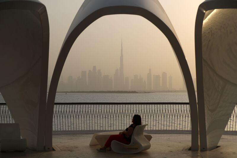 Visitors to Dubai Creek Harbour enjoy the sunset. Chris Whiteoak / The National