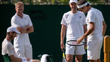 Andy Murray and Roger Federer chat during their practice match. PA