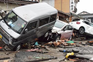 Vehicles sit piled up after being washed up by a tsunami in the city of Suzu, Ishikawa prefecture on January 3, 2024, after a major 7. 5 magnitude earthquake struck the Noto region in Ishikawa prefecture on New Year's Day.  Japanese rescuers scrambled to search for survivors on January 3 as authorities warned of landslides and heavy rain after a powerful earthquake that killed at least 62 people.  (Photo by JIJI Press  /  AFP)  /  Japan OUT