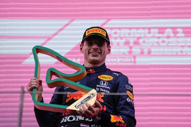 Winner Red Bull's Dutch driver Max Verstappen celebrates with the trophy during the podium ceremony of the Formula One Styrian Grand Prix at the Red Bull Ring race track in Spielberg, Austria, on June 27, 2021.  (Photo by Darko Vojinovic  /  POOL  /  AFP)