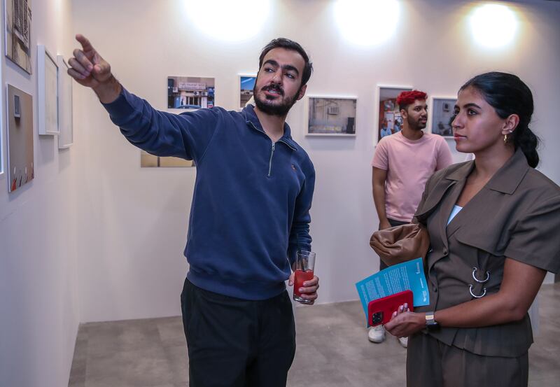 Ahmed Al Kuwaiti in front of his work during the exhibition launch for 50 Years of Cool. Victor Besa / The National