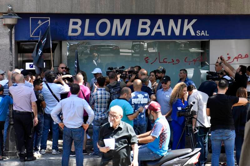 People gather near a Blom Bank branch during an hostage-taking situation in Beirut. EPA