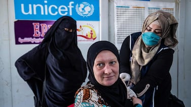 A woman receives a a shot of a Covid-19 vaccine in the Kurdish-run Al Hol camp in Syria. AFP