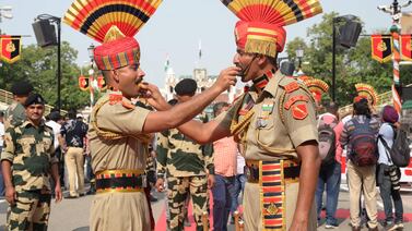 Indian Border Security Force (BSF) personnel offers sweets to each other on the occasion of the country’s 77th Independence Day celebrations at India-Pakistan Wagah Border post, some 35 km from Amritsar on August 15, 2023.  (Photo by Narinder NANU  /  AFP)