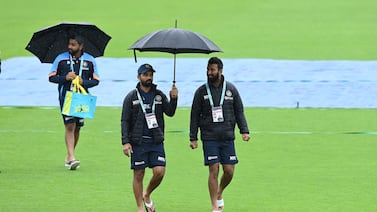 India's Ajinkya Rahane and Cheteshwar Pujara walk on the pitch as rain stops play on the fourth day of the WTC final. AFP