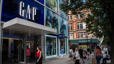 Shoppers pass the GAP store on Oxford Street in London. Consumers scaled back their shopping in May as they chose to eat out instead. Getty Images