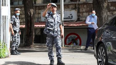 A Lebanese police officer gestures as he stands outside the Justice Palace in Beirut.  Reuters
