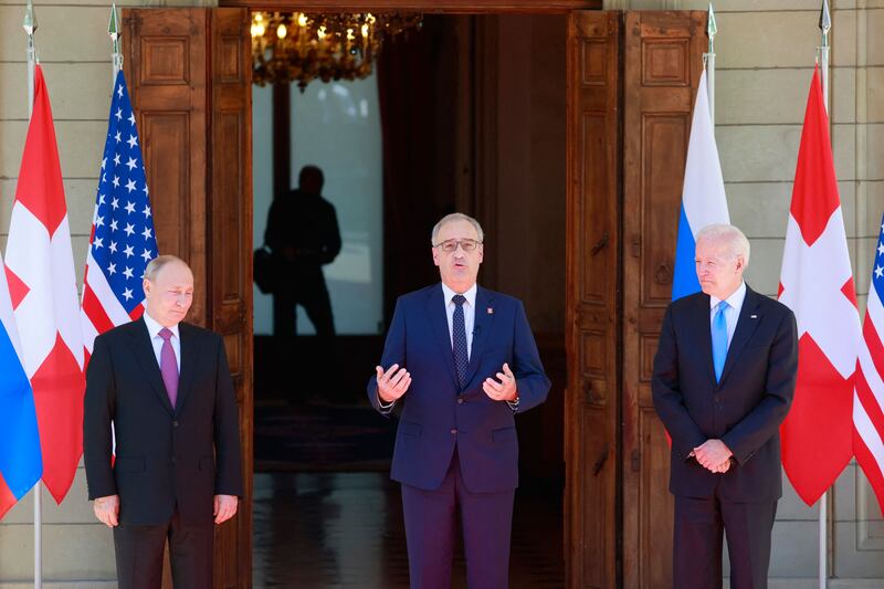Swiss President Guy Parmelin poses for a photograph with Vladimir Putin and Joe Biden. AFP