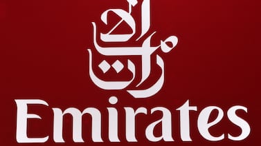 (FILES) This file photo taken on November 16, 2021 shows the logo of Emirates airline on display during the 2021 Dubai Airshow in the Gulf emirate.  - Emirates airline announced a "significantly reduced" annual loss of $1. 1 billion dollars on May 13, 2022, down from $5. 5 billion a year earlier as pandemic travel restrictions ease.  Losses came in at 3. 9 billion dirhams ($1. 1 billion) in the 2021-2022 financial year with revenues up 91 percent as the airline expanded its global capacity and reinstated flights, a statement said.  (Photo by GIUSEPPE CACACE  /  AFP)