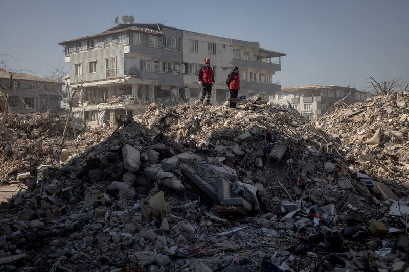 Rescue workers oversee an operation from the top of a pile of rubble on February 15, 2023 in Hatay, Turkey. Getty Images