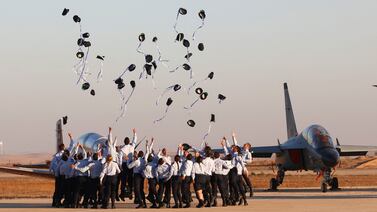 Israeli Air Force pilots throw their hats in the air as they celebrate during an air show at the graduation ceremony of Israeli air force pilots at the Hatzerim Israeli Air Force base in the Negev desert, near the southern Israeli city of Beer Sheva,  on June 24, 2021.  (Photo by JACK GUEZ  /  AFP)