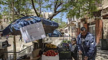 A vendor arranges fresh produce on display for sale at a souk in Sidon, Lebanon. Bloomberg