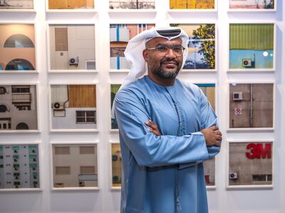 Hussain AlMoosawi in front of his work at 50 Years of Cool. Victor Besa / The National
