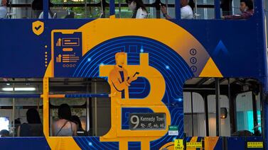 A Bitcoin advertisement on a tram in Hong Kong. China’s biggest banks vowed not to help cryptocurrency customers after the central bank told them to step up enforcement of a government ban. AP