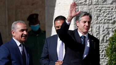 U.S. Secretary of State Antony Blinken waves as he is welcomed by Palestinian Prime Minister Mohammad Shtayyeh, left, on his arrival to meet with Palestinian President Mahmoud Abbas, in the West Bank city of Ramallah, Tuesday, May 25, 2021. (AP Photo/Majdi Mohammed, Pool)