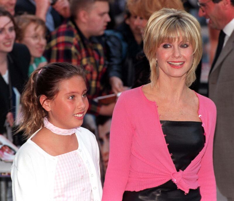 File photo dated 25/06/98 of Olivia Newton-John arrives with her daughter Chloe, for the premiere of the 20th anniversary re-issue of the musical Grease, at the Empire, Leicester Square, London. Dame Olivia Newton-John has died at the age of 73, her widower has confirmed. The British-born singer died "peacefully" at her ranch in Southern California on Monday morning, surrounded by family and friends. Issue date: Tuesday August 9, 2022.