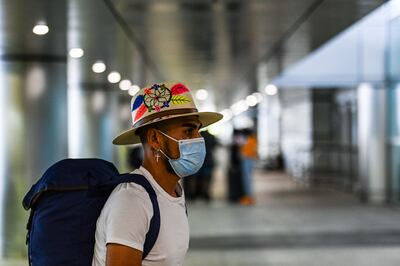 A man wears a mask as he arrives at Miami International Airport (MIA) ahead of the long holiday week-end of Memorial Day in Miami on May 26, 2021. Global air passenger numbers could rebound from the coronavirus pandemic to top 2019 levels by 2023, the International Air Transport Association predicted on Wednesday. / AFP / CHANDAN KHANNA
