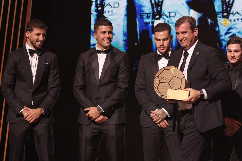 TOPSHOT - Manchester City Spanish CEO Ferran Soriano (2ndR) walks on stage with the trophy as Manchester City receives the Men's Best Club of the Year trophy, next to Manchester City's Portuguese defender Ruben Dias (L), Manchester City's Spanish midfielder Rodri, Manchester City's Brazilian goalkeeper Ederson Santana de Moraes and Ivorian former football player and Manchester City's Argentinian forward Julian Alvarez during the 2023 Ballon d'Or France Football award ceremony at the Theatre du Chatelet in Paris on October 30, 2023.  (Photo by FRANCK FIFE  /  AFP)