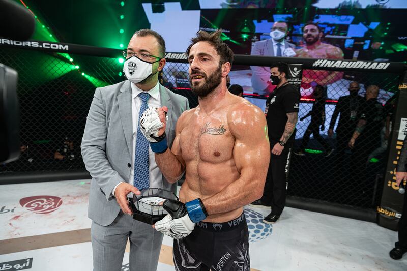 Bellator middleweight veteran Gianni Melillo receives his award at the UAE Warriors 20 from Fouad Darwish, managing director of organisers Palms Sports, after defeating Mohammad Karaki.