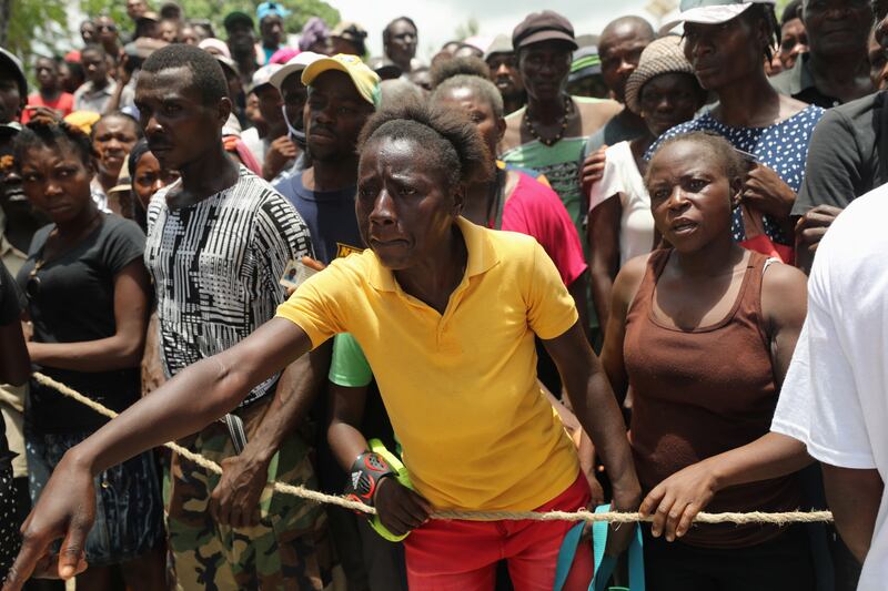 Camp-Perrin residents wait to receive food from the World Food Programme (WFP) in Camp-Perrin near Les Cayes, after the earthquake that took place on August 14th, in Haiti, August 19, 2021.  REUTERS / Henry Romero