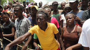 Camp-Perrin residents wait to receive food from the World Food Programme (WFP) in Camp-Perrin near Les Cayes, after the earthquake that took place on August 14th, in Haiti, August 19, 2021.  REUTERS / Henry Romero