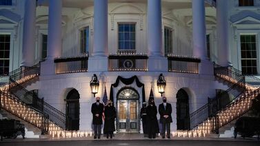US President Joe Biden, first lady Jill Biden, Vice President Kamala Harris and husband Doug Emhoff hold a moment of silence and candlelight ceremony in honour of those who lost their lives to Covid-19 on the South Lawn of the White House in Washington, February 22, 2021. AFP