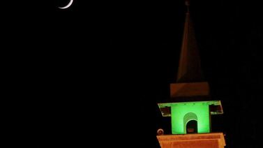 A crescent moon is seen above a mosque on the second day of Ramadan in Beirut, Lebanon. Jamal Saidi / Reuters